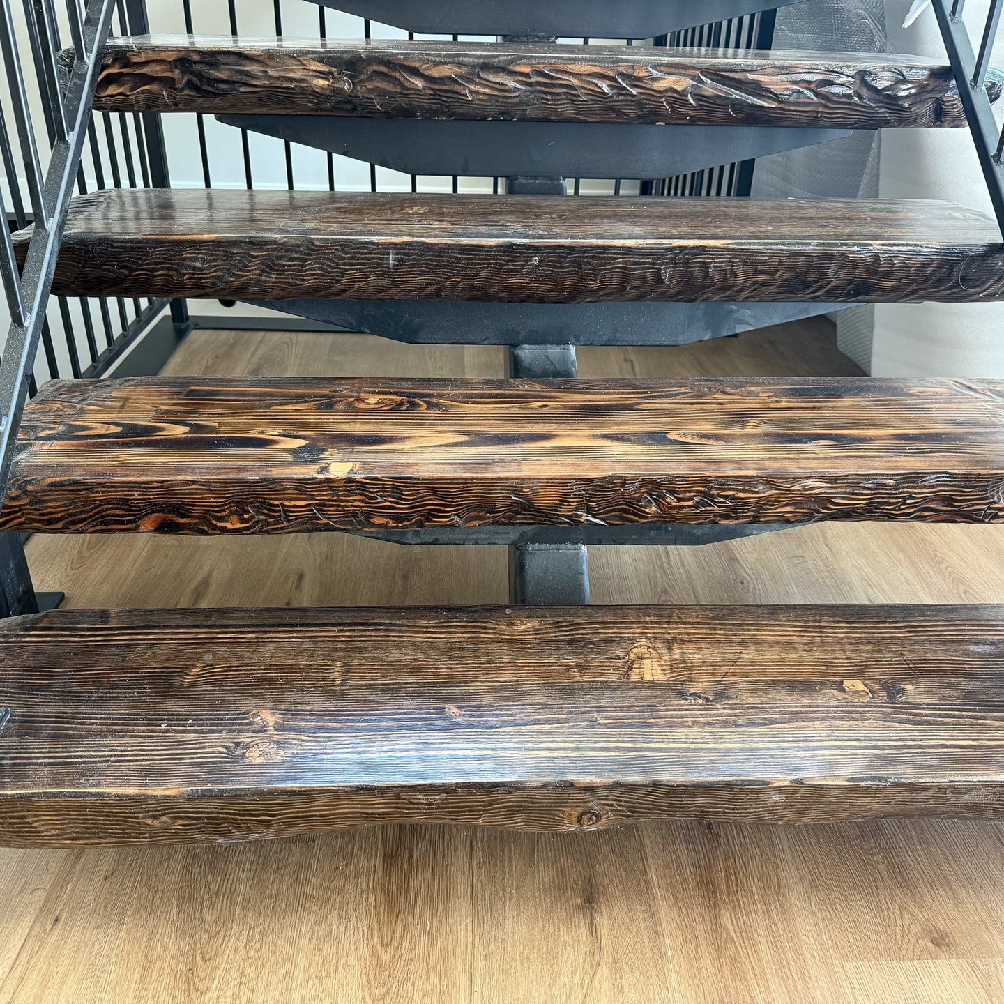Restored wood stair treads with a dark stained finish
