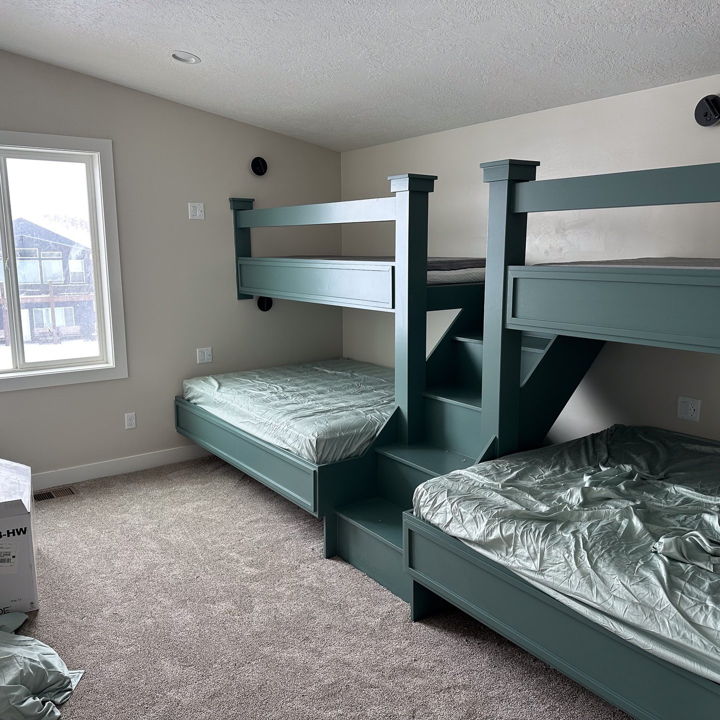 Painted bunk beds in a finished bedroom