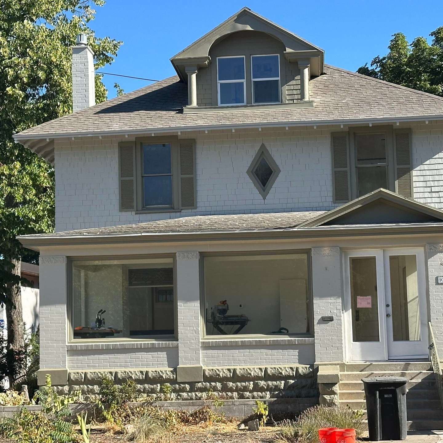 Older home exterior with painted siding, porch, and trim
