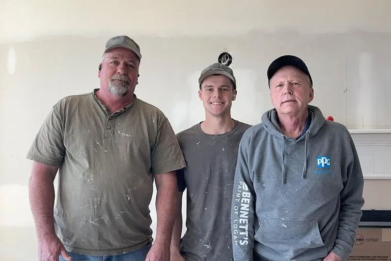 Three painters standing together at a Straight Edge jobsite