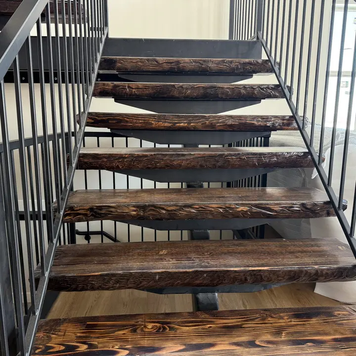 Open staircase with finished wood treads and metal railing