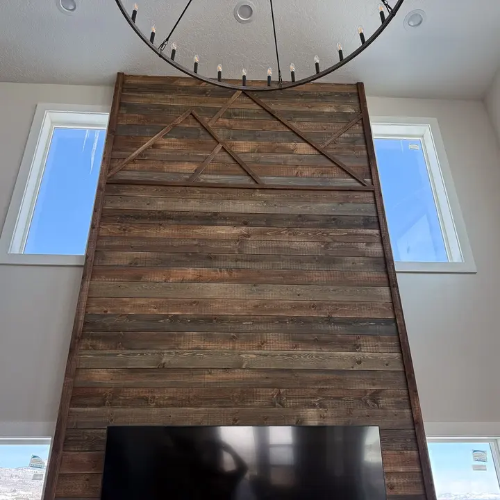 Tall rustic wood accent wall between two windows