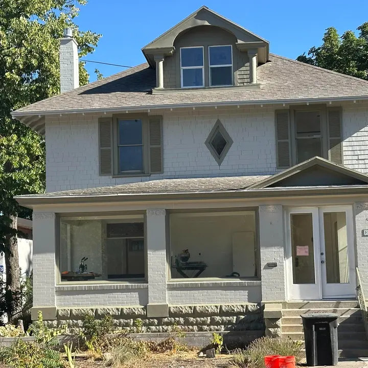 Older home exterior with painted siding, porch, and trim