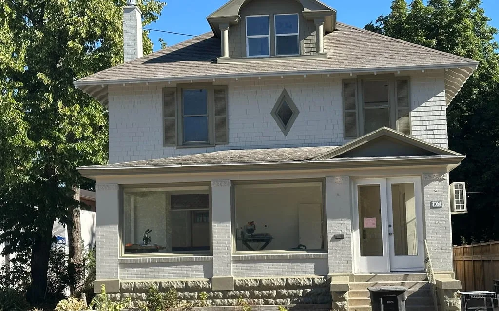 Older home exterior painted in white and gray